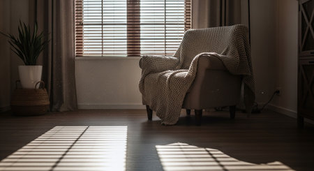 Comfortable armchair in living room with blinds on the windowの素材