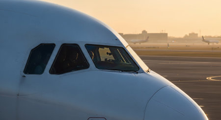 Airplane on the runway of the airport at sunset. Shallow depth of field.の素材