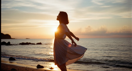 Silhouette of a little girl at sunset on the beach.の素材