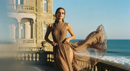Beautiful girl in a long dress on the background of the seaの素材