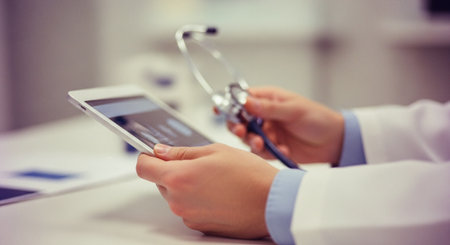close up of female doctor with stethoscope and tablet pc computerの素材
