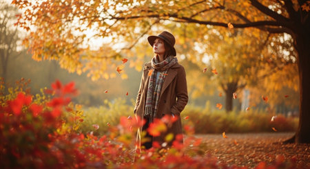 Autumn fashion. Portrait of beautiful young woman in autumnal park.の素材