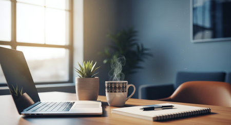 A cozy workspace featuring a laptop, a steaming cup of coffee, a potted plant, and a notepad with a pen, illuminated by natural light from a windowの素材