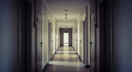 Empty Institutional Hallway With Dramatic Lightの素材