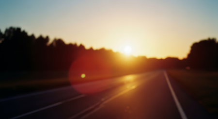Blurred background of the road at sunset. Abstract blurred background of the roadの素材