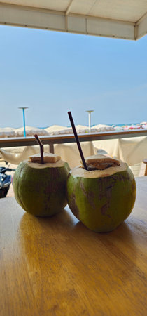 Coconut drink on the table in the beach restaurant, Thailand