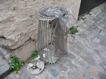 Metal trash can on the street in Paris.の写真素材