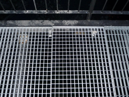 Steel grating of the drainage system, closeup of photo.の写真素材