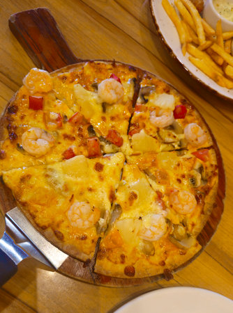Pizza with prawns, shrimp and mushrooms on wooden tableの写真素材