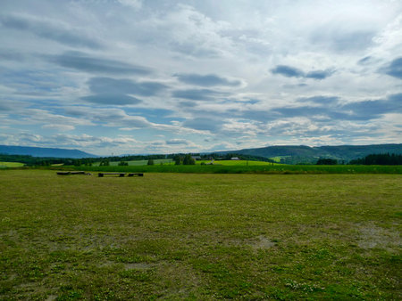 Landscape with green meadows and blue sky with white clouds.の写真素材