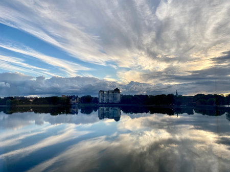 Reflection of the sky and clouds in the water of a lakeの写真素材