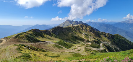 Panoramic summer view of the Aibga Ridge mountain range and hiking trails from Rosa Peak, Sochi, Russia.の写真素材