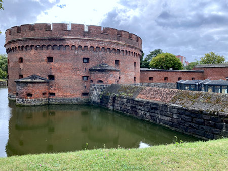 August 30, 2022, Kaliningrad, Russia. Historic red brick Dohna Tower in Kaliningrad surrounded by a defensive moat and lush greeneryのeditorial素材