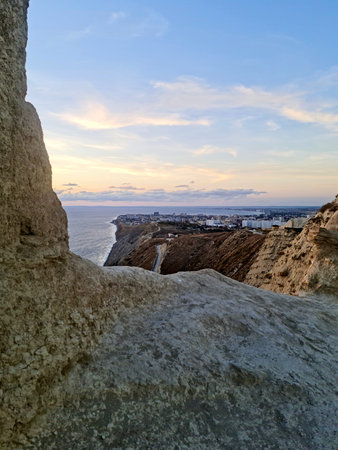 Scenic vista of Anapa city and Black Sea coast framed by sandstone rocks. Golden hour landscape in Supsekh, Russia.の写真素材