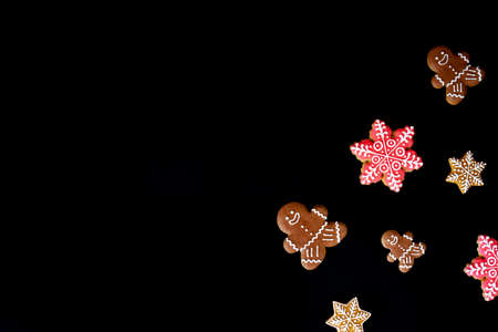 Delicious homemade gingerbreads. Fresh cookies on a black background. Perfect festive backdrop for your text and postcard. Flatlay style.の写真素材