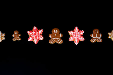 Delicious homemade gingerbreads. Fresh cookies on a black background. Perfect new year decorations....