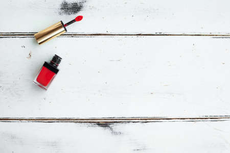 Opened coral multi-functional tint for everyday makeup on white wooden background. Especially for cheeks and lips. 2 in1 beauty musthave. Luxury cosmetic brand. Flatlay. Copyspace.の写真素材