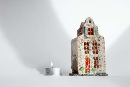 Ceramic Art. Little Sculpture Of Belgium House with burning candle.の写真素材