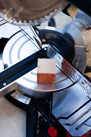 Electric tool with circular metal blade for woodworking. Process of sawing a pine wood.の写真素材