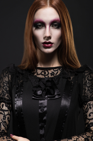 Portrait of gothic girl with black eyes in dark clothesの写真素材