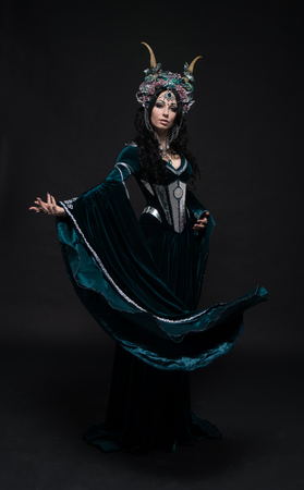 Beautiful fantasy elf woman in flower crown and medieval dressの写真素材