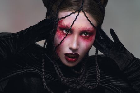 Woman with creative red make-upの写真素材