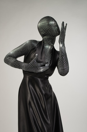 Woman wrapped in black robesの写真素材