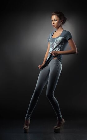 Young fashionable girl in blue jeansの写真素材