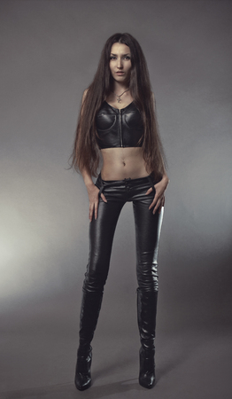 Brunette woman in black leather costumeの写真素材