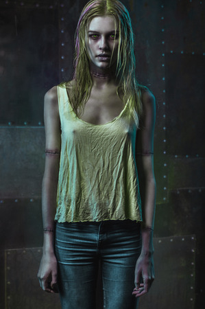 Blonde zombie woman on dark backgroundの写真素材