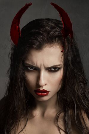 Brunette model with devil hornsの写真素材