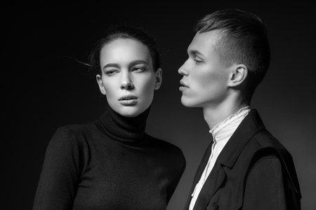 Young couple posing on dark backgroundの写真素材