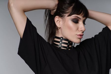 Portrait of beautiful brunette woman with leather black chokerの写真素材