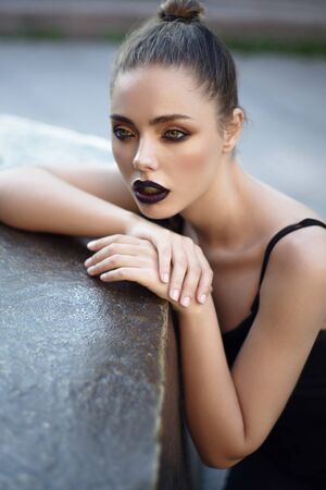 Street portrait of young woman with fashion makeupの写真素材