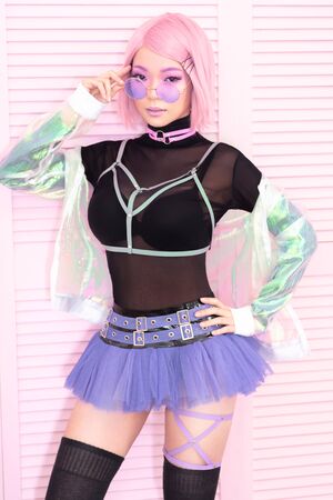 Seductive asian woman with pink hair in sexy underwear posing on pink backgroundの写真素材