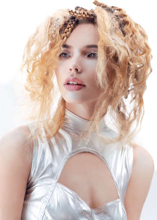 Model with creative futuristic hair style and silver clothes. Studio portrait on white backgroundの写真素材