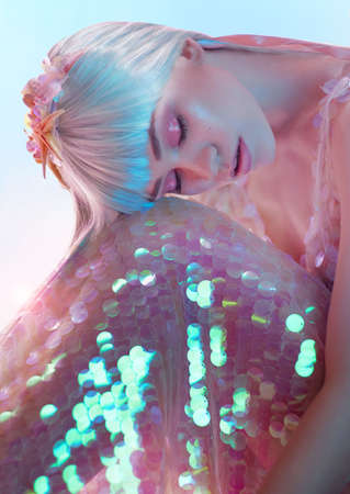 Fashion photography. Young model posing in studio in beautiful pink dressの写真素材