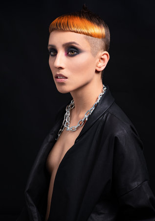 Portrait of woman with creative colorful orange haircut. Studio portraitの写真素材