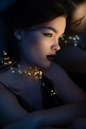 Closeup Portrait of young woman with makeup and christmas lights
