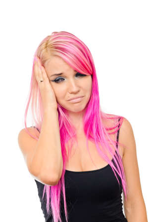 Pink hair woman touches her head as if having headache.の写真素材
