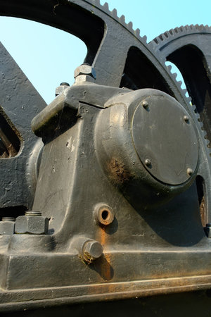 Giant old rusted machinery cogwheels detail with teeth, cobwebs and rust spots. Industrial...