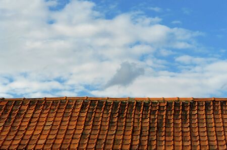 Simplistic binary concept of a rooftop with old pantiles and sky, with a high degree of repetition, perfectly horizontal for banners in a surrealistic mood.の写真素材