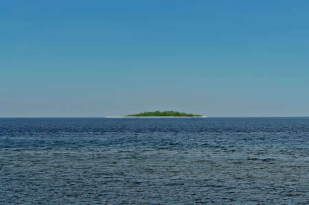 Tropical island in exotic sea. Very simple concept of resort, hide-away, leisure, relax, relaxation.の写真素材