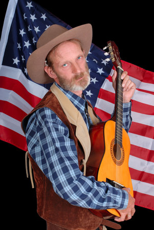 Senior drunken American Western cowboy with acoustic guitar, backed by the stars and stripes flag.
