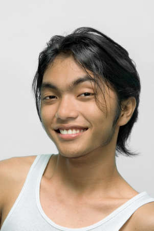 Portrait of a smiling happy East Asian teenager.の写真素材