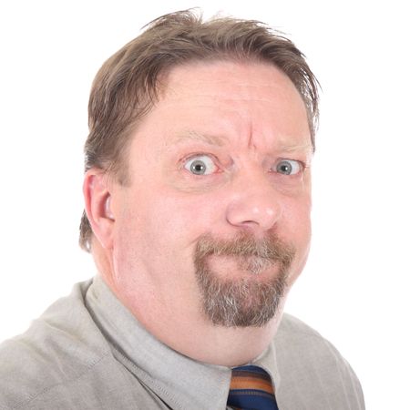 Cropped portrait of stern, angry and frowning businessman with peering eyes, isolated over white.の写真素材