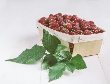 Collected raspberries in a basket. Side view.
