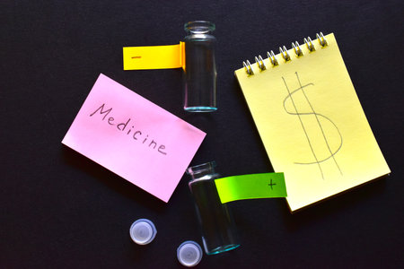 Two notebooks and glass medicine bottles with labels on a black background