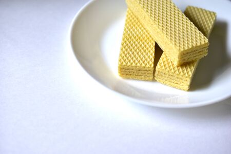 Some delicious sugar waffles on a white plateの写真素材