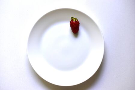 Sliced strawberries or Victoria on a white plateの写真素材
